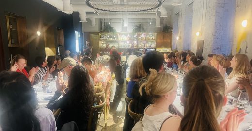 Large group sitting at tables.