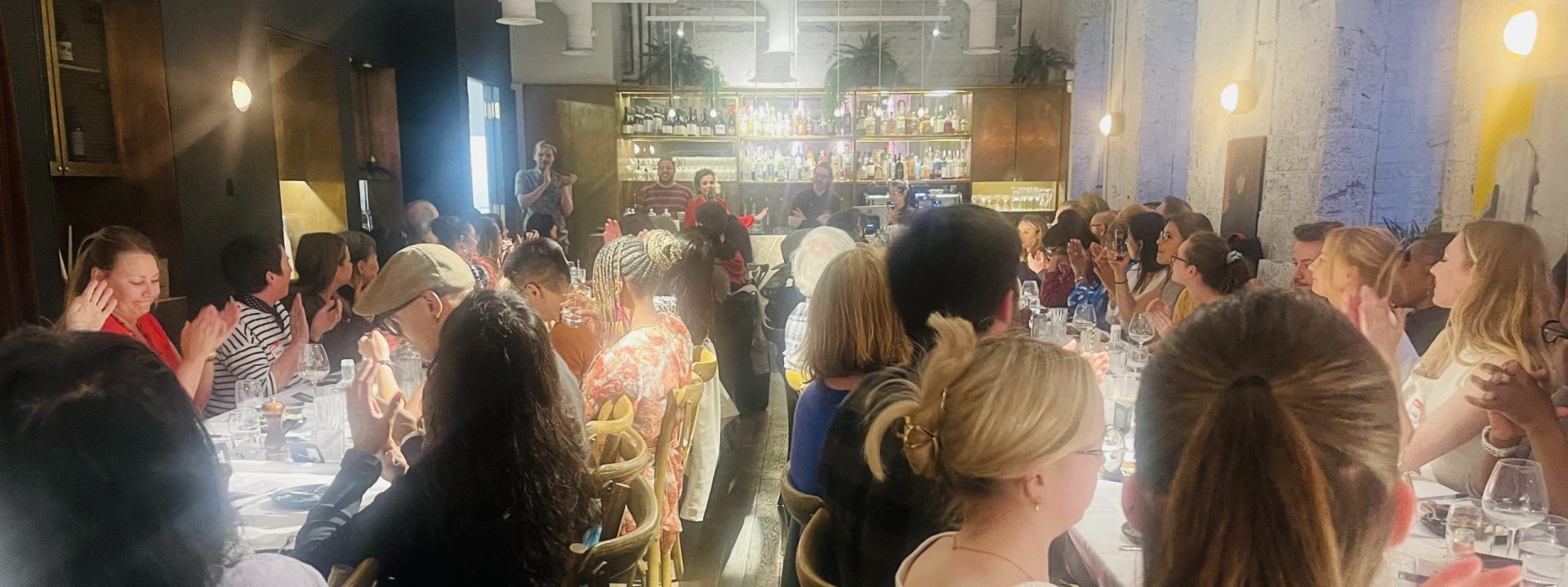 Large group sitting at tables.