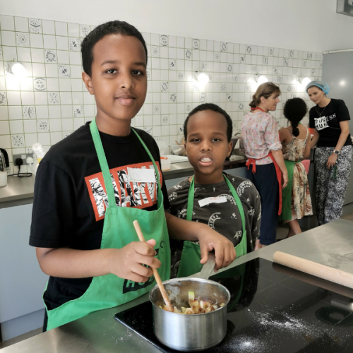 Young people cooking in the Nourish Hub training kitchen.
